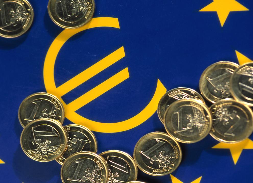 Official symbol of the euro with 1 euro coins surrounding it.