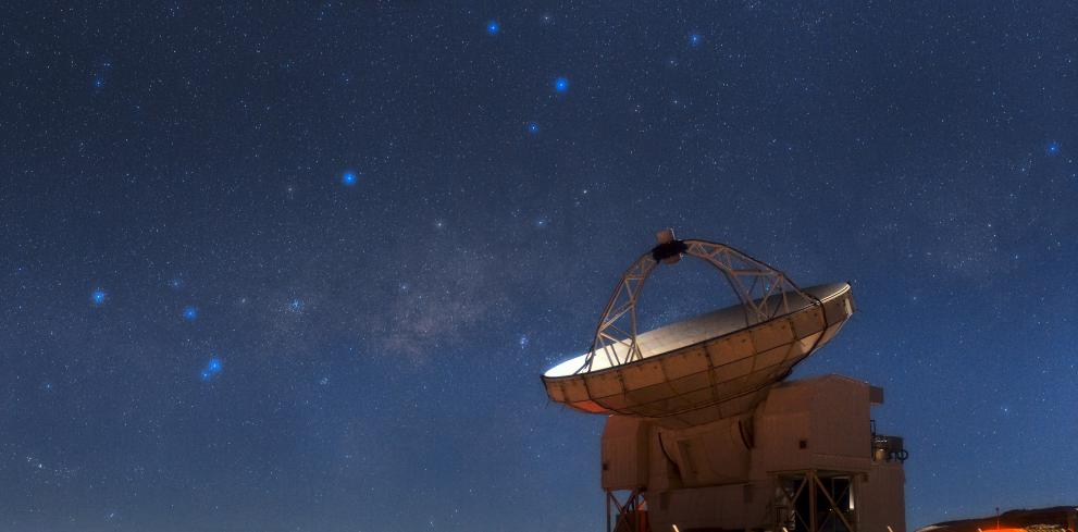 The Atacama Pathfinder Experiment telescope looks skyward during a bright, moonlit night
