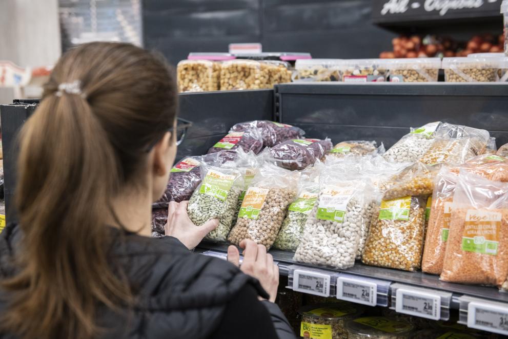 A young woman looking at pulses in a supermarket