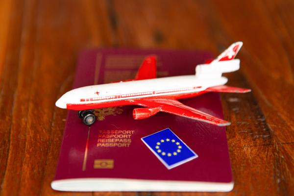 Miniature airplane placed on a passport
